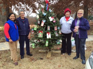 Club members decorate the Cary Woman’s Club’s “Gifting Tree” project in downtown Cary, December 2014